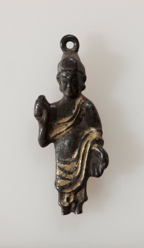 Buddha figure with raised right hand and lowered left hand in robe