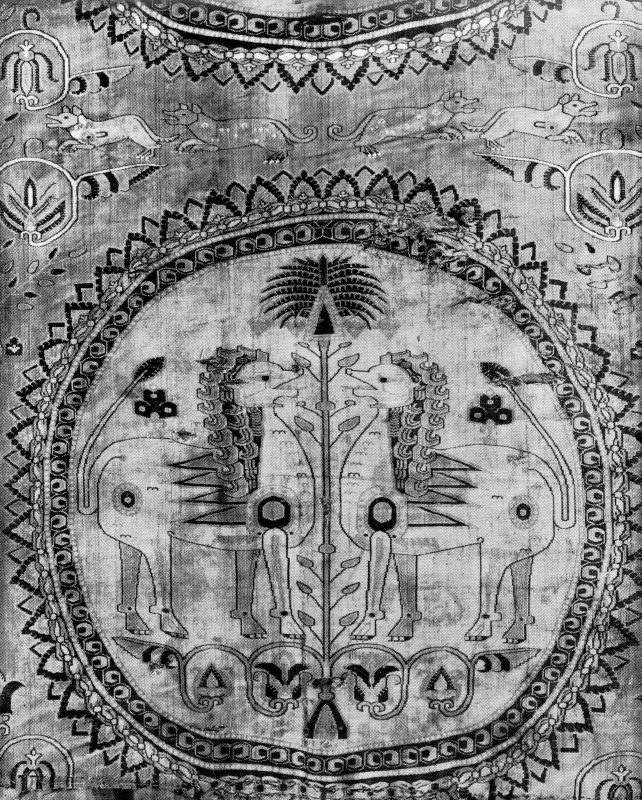 Roundel on a textile with two facing lions separated by a vegetal form