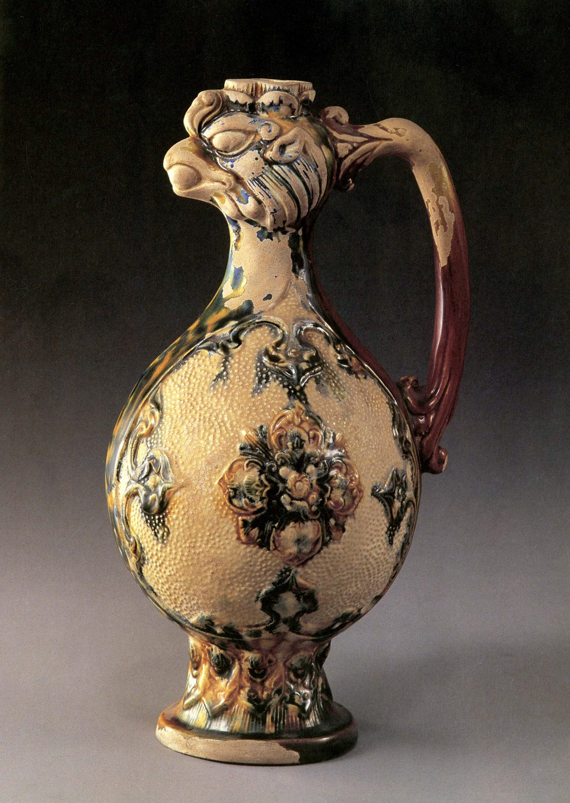 Ewer with bulbous body and bird face opening