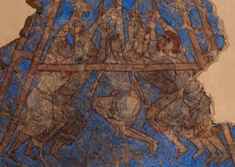 fragment of wall painting showing five men operating a siege machine