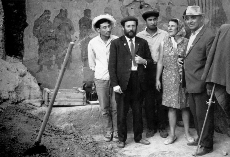 Historic photograph of archaeologists in front of wall paintings