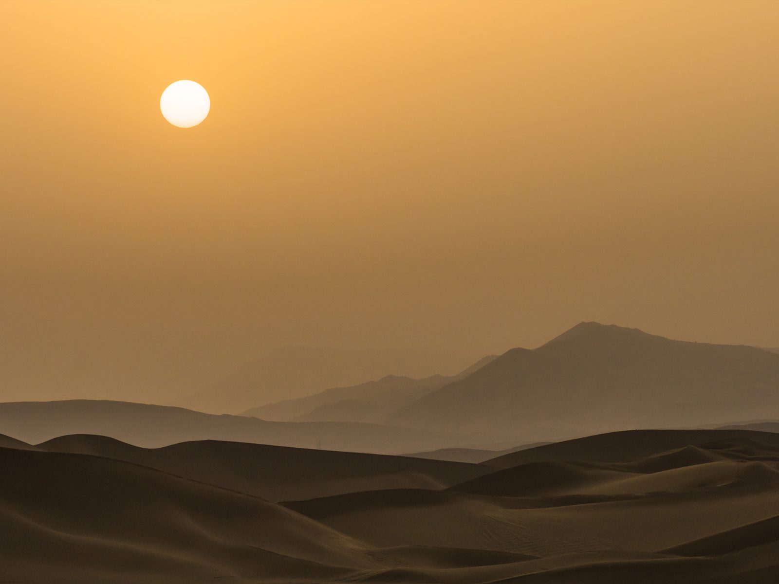 Silhouette of sunset on the desert in Xinjiang Uygur Autonomous Region, China. Photograph © iStock.com/Centuryboy.