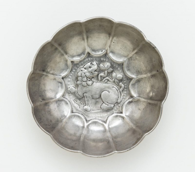 Silver lobed bowl with prancing lion at the center as well as vegetal forms