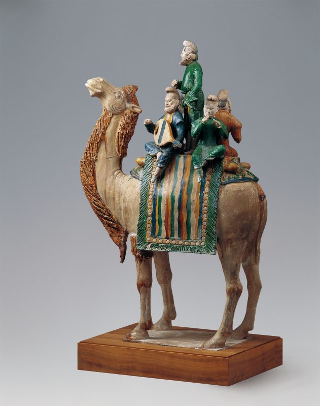 Several musicians on a camel